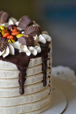 Chocolate stout cake with peanut butter buttercream, chocolate ganache, and Reeses Peanut butter Cups & Pieces!