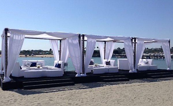 Draped Wood Cabanas with white Lounge sofas