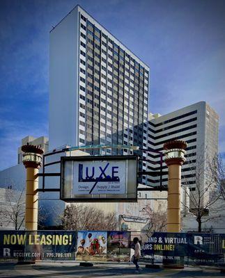 Two apartment towers of Reno City Center with signs of the construction company and apartment leasing company