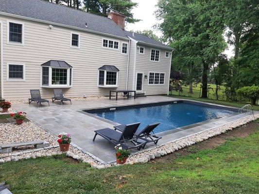 Porcelain Pavers w/ Blue Stone coping after rain.