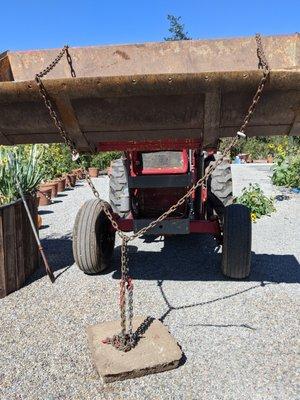 The door weighs 75 pounds or so.  The loader on your tractor will pull it easily.