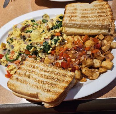 The "Dolly Parton" scramble with country potatoes and extra peppers and onions ($1 extra) and AWESOME sourdough toast.