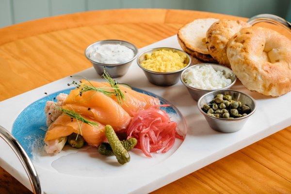 Smoked Salmon Board
 Smoked and cured salmon, house pickles, Italian Capers, dill creme fraiche, organic boiled eggs, and onion bagel