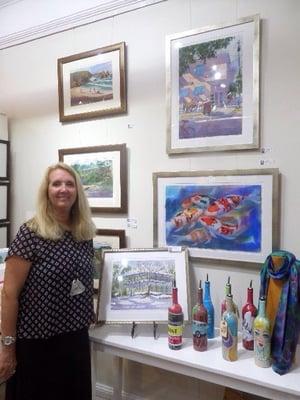 Karen Beauprie, partner and resident watercolor artist, in front of her work during a first Friday event.