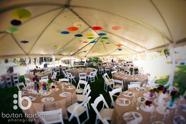 Colorful parasols hanging inside a 40 ' x 85' tent, perfect for this garden party themed wedding. photo credit Boston Harbor Photography.