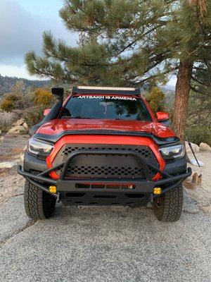 Installed front metal bumper, headlights, custom body trimming to fit exactly, off-road accessories and lights, snorkel, and light bar.