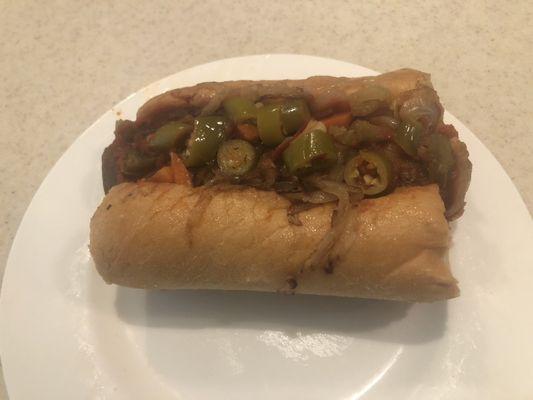 Italian Sausage sandwich with grilled onions, marinara sauce and hot giardiniera peppers