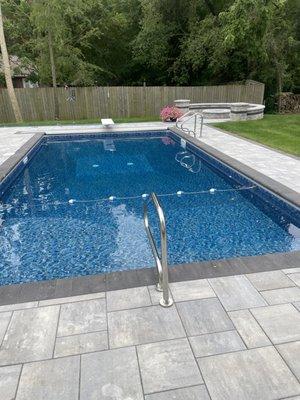 Vinyl Liner pool with custom step and pavers