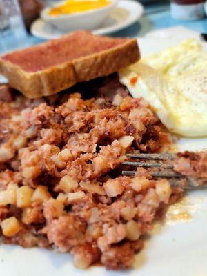 Corned beef hash, eggs Sunnyside up and toast