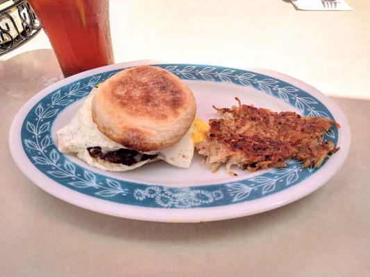 Custom breakfast sandwich with sausage patty, cheese and hash browns