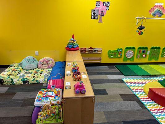 The baby play area features age-appropriate toys and activities that stimulate sensory and motor skills.