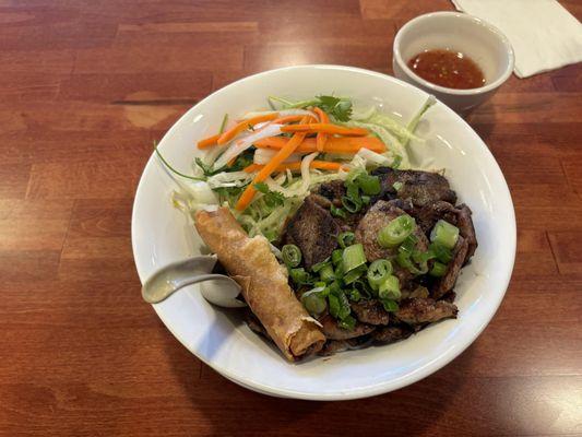 Grilled pork and spring roll bun noodle bowl.