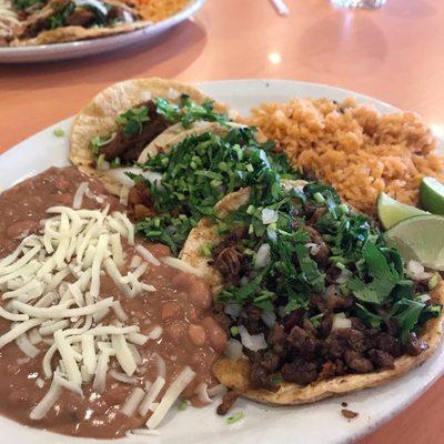 Three tacos combo meal, 2 al pastor, 1 carne asada with rice and beans.