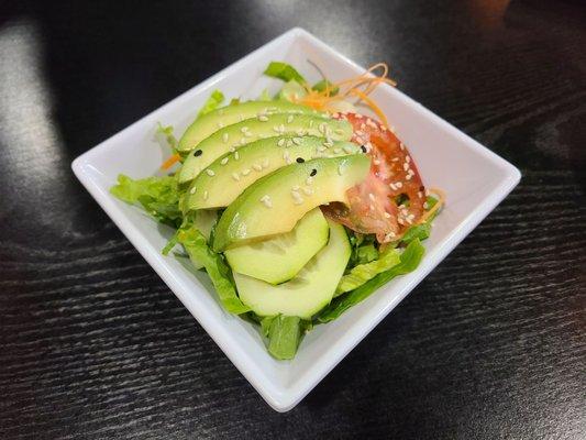 Avocado salad, dressing presented separately.