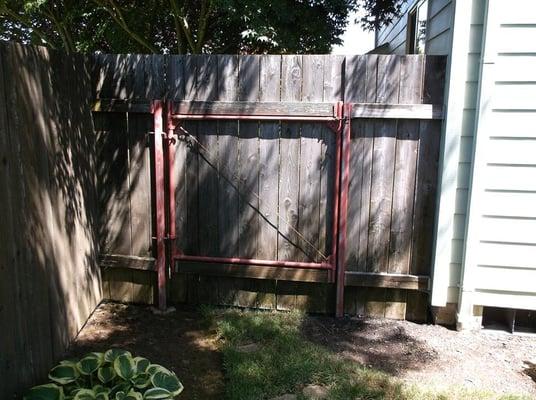 Before: Steel framed wood gate on Steel posts