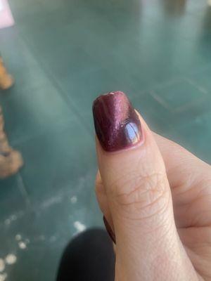 The nail that the nail tech "fixed." Lumpy and uneven.