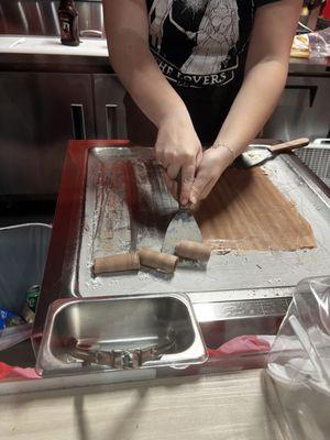 Watching the chocolate ice cream get rolled after chilling