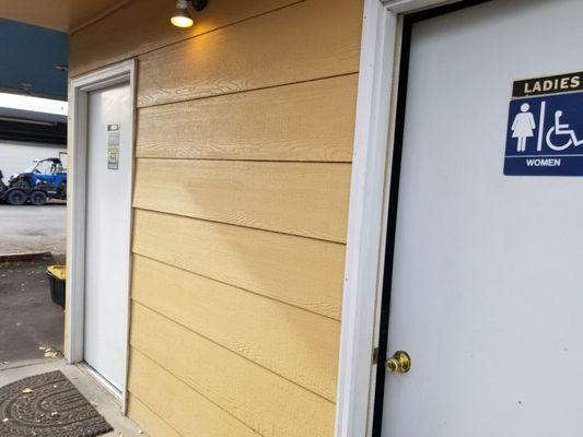 Restrooms outside at the end of the building.