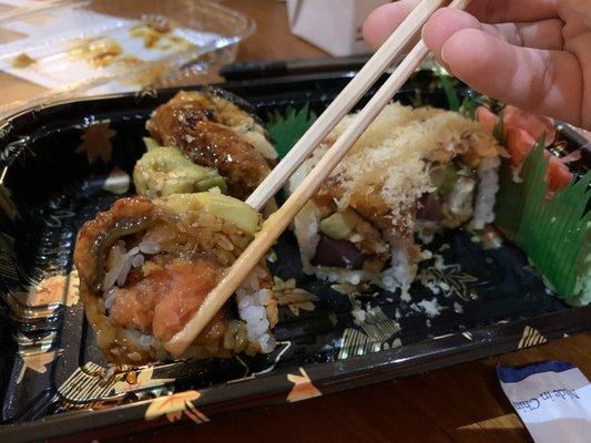 brown dragon roll (in chopsticks) and Mario roll