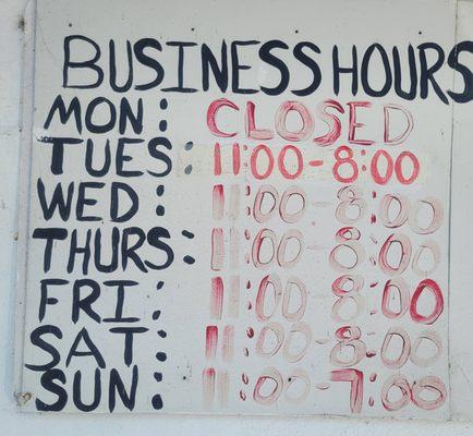 The business hours look like they were written with a finger dipped in blood