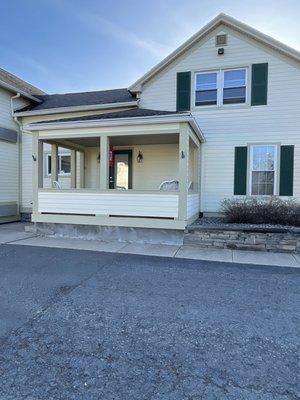 Entrance to house via side door with own porch