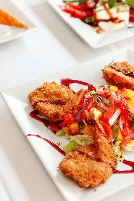 Coconut Crusted Shrimp served over mango salad and drizzled with raspberry sauce