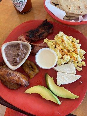 Breakfast plate  Platano maduro aguacate quedo mantequilla two eggs of your choice steak chorizo beans and queso