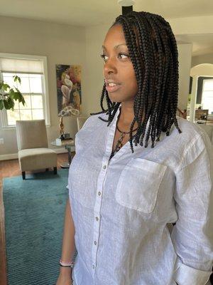 Medium knotless braids with rubber bands on the ends.