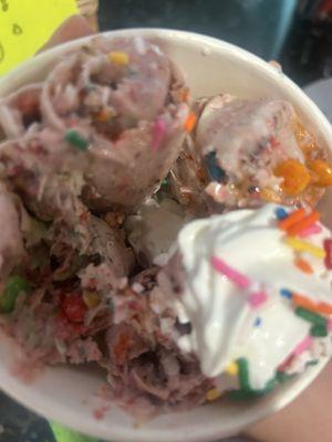 Vanilla ice cream with brownie,m&m,freeze dried strawberries, shredded coconut, whip cream, fruity pebbles  and sprinkles!