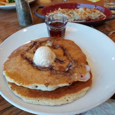 Cinnamon roll pancakes and a side of hashbrowns.