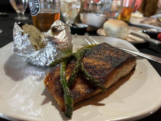 Blackened salmon with baked potato.