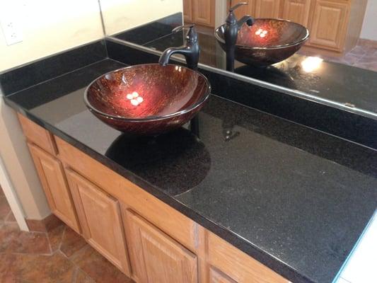 Granite Countertops with vessel sinks and faucet.