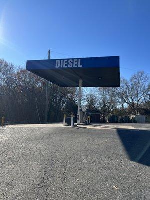 Diesel pumps behind store.