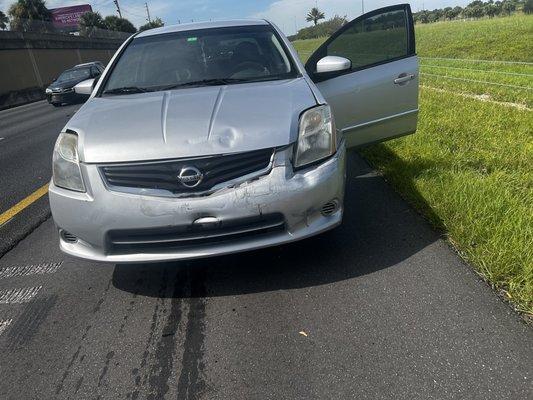 My car after the accident, frame messed up and driver side headlight left broken.