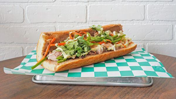 YC Banh Mi

French baguette spread with a hoisin pork butter, five spice grilled chicken, pickled veggies, jalapeño and cilantro aioli