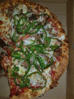 This pizza was ordered as sausage Peppers mushrooms onions heavy on the sausage light on the peppers