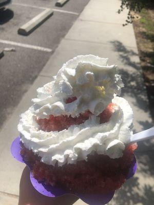 Stuffed sugar free strawberry cheesecake with added whipped cream in a flower cup