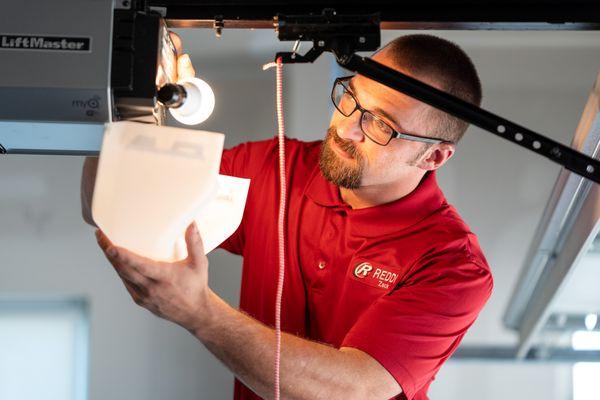 Garage Door tech installing a garage opener in Wichita, KS.