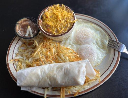 Eggs, hash browns, salsa, green chili and a tortilla.