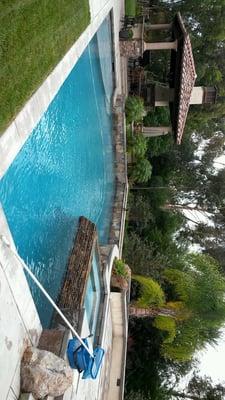 Spa above the pool with nice landscaping