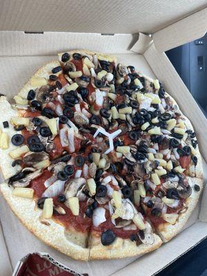 Pan pizza with no cheese, extra olives, pineapple and onion