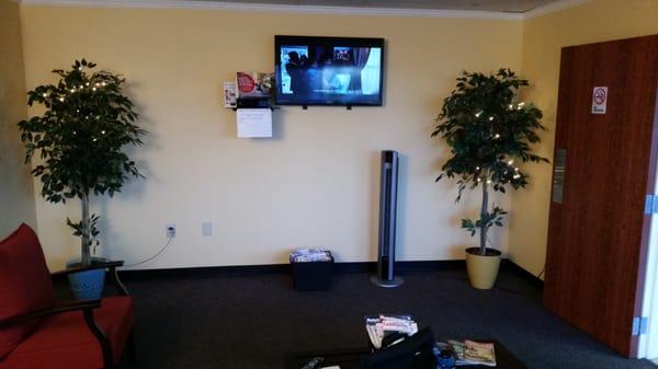 Other half of the waiting room. Tv remote is on the table to change channels.