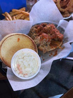 Pulled Cajun shredded pork sandwich and seasoned french fries.