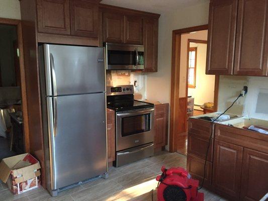 Cabinets, new floor, appliances installed, just set up for countertops to go in.