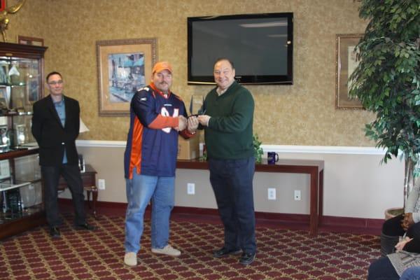 Eric Schulz presented with outstanding service for the Teams Bank-Owned Property Division...