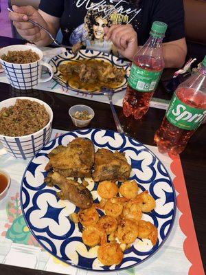 Creole Chicken & Shrimp and Oxtails with rice and peas and pink potatoes.