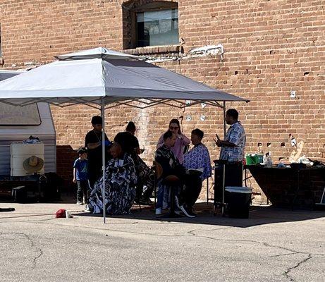 Owner, David and students cutting hair at cloud, covered streets event in Central Phoenix