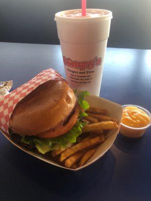 Wimpy burger with fries and cheese sauce on the side.