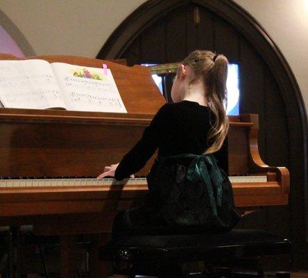 A student plays in the winter recital.