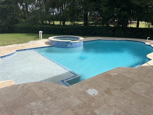 Newly renovated travertine deck, patio, spa and waterfall addition.